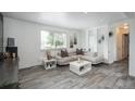 Comfortable living room showcasing neutral tones, modern decor, and natural light through the window at 772 Lewiston St, Aurora, CO 80011