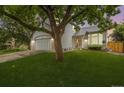 Charming two-story home boasts a well-manicured lawn, attached two car garage, and mature landscaping at 11263 Vrain Dr, Westminster, CO 80031