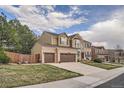 Charming two-story brick home with a manicured front yard and an attached two-car garage at 11710 Crow Hill Dr, Parker, CO 80134