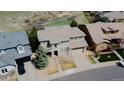 Overhead shot of the home featuring a neutral exterior color, landscaped yard, and tile roof at 3873 Fairbrook Pt, Highlands Ranch, CO 80130