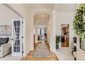 Bright foyer showcasing hardwood floors, elegant archways, and an open floor plan at 17423 Cornerstone Ln, Parker, CO 80134
