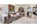 Open-concept living room and kitchen featuring modern decor and appliances at 19118 E 54Th Pl, Denver, CO 80249