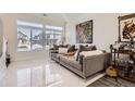 Modern living room with large windows, marble floors, contemporary furniture, and stylish décor at 19118 E 54Th Pl, Denver, CO 80249