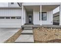 Inviting front entrance with concrete steps and a covered porch, leading to a stylish front door at 11454 Stonewash St, Littleton, CO 80125