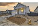 Beautiful front yard with minimal xeriscaping and a charming white exterior at 11454 Stonewash St, Littleton, CO 80125
