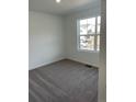 Bright bedroom with plush carpeting and a large window offering natural light at 22016 E 39Th Pl, Aurora, CO 80019