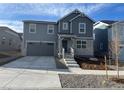 Charming two-story home featuring a modern exterior with a two-car garage and stone accents at 22016 E 39Th Pl, Aurora, CO 80019