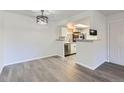 Open dining area with modern lighting and view into kitchen at 8225 Fairmount Dr # 105, Denver, CO 80247