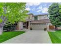 Charming two-story home featuring a well-manicured lawn and welcoming front porch at 10609 Chadsworth Ln, Highlands Ranch, CO 80126