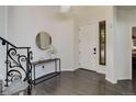 Bright foyer featuring dark wood floors, white walls, and an elegant black staircase at 10609 Chadsworth Ln, Highlands Ranch, CO 80126