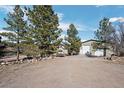 Exterior shot of property with detached garages, and large gravel parking area at 4249 Oak Grove Way, Castle Rock, CO 80108