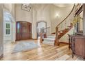 Elegant foyer with a grand staircase, hardwood floors, and a soaring ceiling at 9121 Sunshine Meadow Pl, Parker, CO 80134