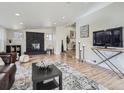 Bright living room featuring a stone fireplace, hardwood floors, and ample natural light at 35 Everett St, Lakewood, CO 80226
