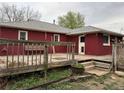 Backyard view of the wood deck and faded brick exterior of the home at 1985 Blackhawk St, Aurora, CO 80011