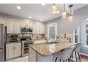 Bright kitchen with stainless steel appliances, granite countertops, and modern pendant lighting at 8360 W 87Th Dr # D, Arvada, CO 80005