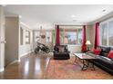 Open living space featuring hardwood floors, large windows, and ample natural light at 10127 Bluffmont Ln, Lone Tree, CO 80124