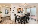Cozy dining area with wood-look flooring, modern table set, and sliding glass door to the outside at 20000 Mitchell Pl # 51, Denver, CO 80249