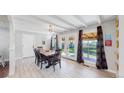 Dining room featuring white wood trim, neutral colors, and a view of the fenced backyard at 3067 S Holly Pl, Denver, CO 80222