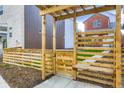 Private backyard area with wooden pergola, fencing, and landscaping at 6926 Kendrick Ln, Arvada, CO 80007