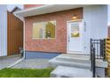 Close-up of the front entrance showing the door, steps, and house number at 6926 Kendrick Ln, Arvada, CO 80007