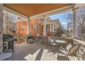 Relaxing covered back porch with outdoor seating, a grill, and a view of the surrounding greenery at 54 S Emerson St # 4, Denver, CO 80209