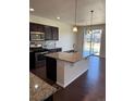 A well-equipped kitchen featuring stainless steel appliances, a center island, and modern finishes at 14883 E Crestridge Dr, Centennial, CO 80015