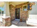 Welcoming front porch with stone accents and decorative bear figurines at 5722 S Flat Rock Way, Aurora, CO 80016
