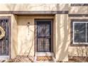 Inviting entrance with a decorative door, a welcome mat, and natural stone landscaping at 3512 S Kittredge St # C, Aurora, CO 80013