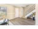 Sunlit living area featuring sleek floors, modern staircase, and neutral walls for a versatile living space at 3512 S Kittredge St # C, Aurora, CO 80013