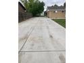 An expansive, long concrete driveway that leads to the garage at 8220 E 104Th Way, Henderson, CO 80640