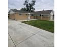 An exterior shot of the home highlighting the long driveway and lawn at 8220 E 104Th Way, Henderson, CO 80640