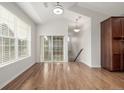 Open dining room with hardwood floors, and access to backyard area through glass sliding doors at 11972 W Long Cir # 204, Littleton, CO 80127