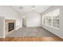 Bright living room with carpet, fireplace, and vaulted ceilings leads to the other rooms at 11972 W Long Cir # 204, Littleton, CO 80127