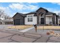 Charming home exterior with a stone-accented front, tasteful landscaping, and a welcoming entryway at 12215 Viewpoint Dr, Lakewood, CO 80401