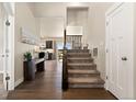 Open entryway with hardwood floors, stairs and study nook at 208 Dorothy Dr, Berthoud, CO 80513
