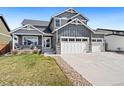 Two-story home with a well-maintained lawn and three car garage at 208 Dorothy Dr, Berthoud, CO 80513