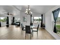Open-concept dining area features a stylish chandelier and light tile flooring at 243 Cherokee Ct, Brighton, CO 80603