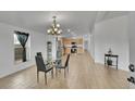Open-concept dining area featuring a stylish chandelier and light tile flooring at 243 Cherokee Ct, Brighton, CO 80603