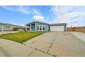 Charming home featuring a well-maintained lawn, covered porch, and an attached two-car garage at 243 Cherokee Ct, Brighton, CO 80603