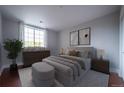 Serene bedroom with a comfortable bed, soft neutral tones, and a bright window with decorative curtains at 6000 W Floyd Ave # 107, Denver, CO 80227