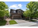 Charming two-story home features a three-car garage, stone accents, and well-maintained landscaping at 5301 Clovervale Cir, Highlands Ranch, CO 80130