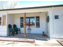 Charming covered front porch enhanced with seating, decorative plants, and tasteful decor that adds warmth and curb appeal at 3040 S Clermont Dr, Denver, CO 80222