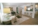 Bright and airy living room featuring a seamless flow to the kitchen and bar area, perfect for modern living at 3040 S Clermont Dr, Denver, CO 80222