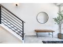 Inviting entryway with stylish bench, mirror, staircase, and modern decor at 9052 Harlan St, Westminster, CO 80031