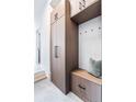 Well-organized mudroom with custom cabinets, built-in bench, and convenient storage hooks at 9052 Harlan St, Westminster, CO 80031