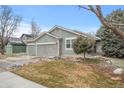 Charming single-story home features manicured front yard and two-car attached garage at 1668 Holeman Dr, Erie, CO 80516