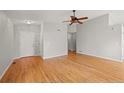 Spacious living room features hardwood floors, fan and neutral wall color at 1668 Holeman Dr, Erie, CO 80516