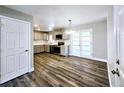 Updated kitchen with stainless steel appliances, gray cabinetry, and adjacent dining area at 6717 Lee St, Arvada, CO 80004