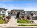 Beautiful two-story home boasting a large driveway, well-manicured lawn, and attractive stone and stucco facade at 15033 Delhi Ave, Parker, CO 80134