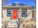 Charming home with a vibrant orange front door, accented by a blue trim and lovely curb appeal at 1125 E Kentucky Ave, Denver, CO 80209